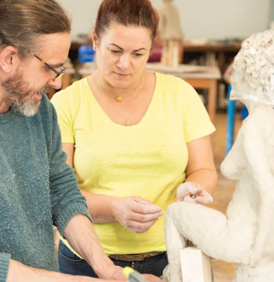 Jamie Frost teaching clay figure sculpture.