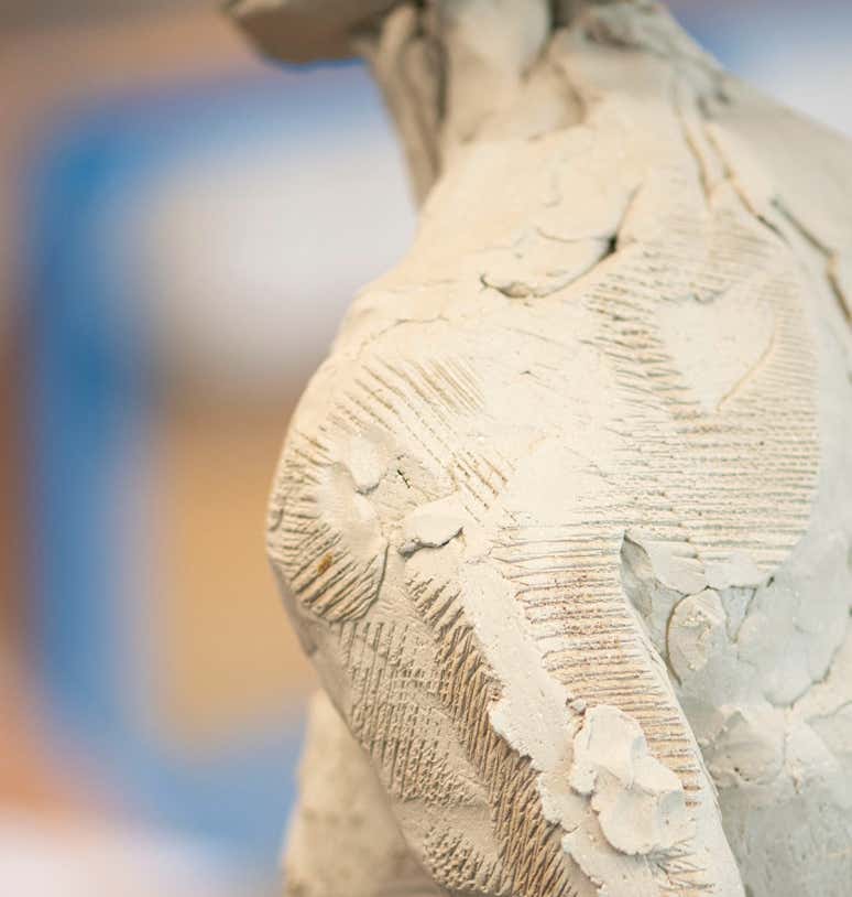 Textures in clay sculpture of figure.