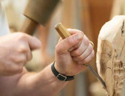 Carving wood in sculpture class